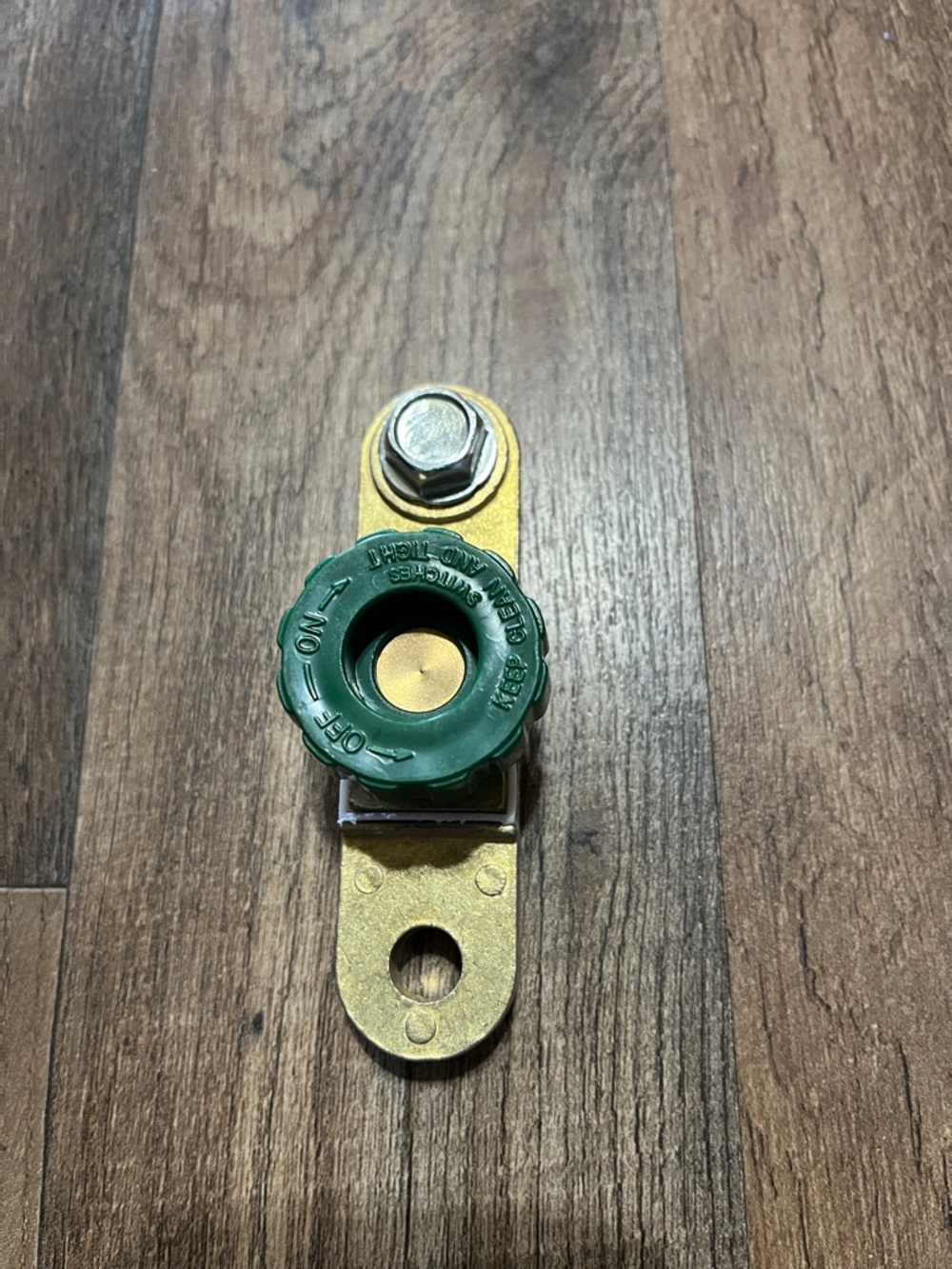 Green Rotary Battery Disconnect Switch on Brass Strap
